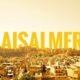 A panoramic view of Jaisalmer city with its iconic Golden Fort under a warm golden sky.
